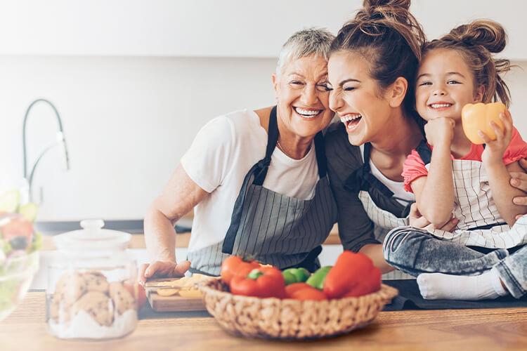 women & child laughing & cooking
