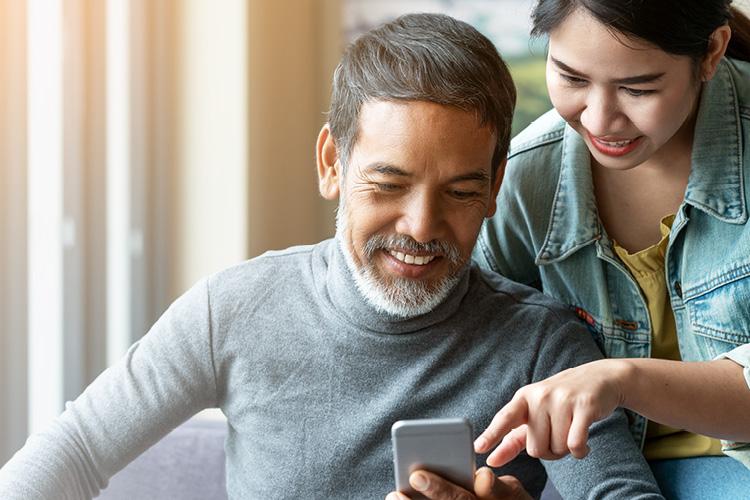 Man and woman checking the status on a smartphone