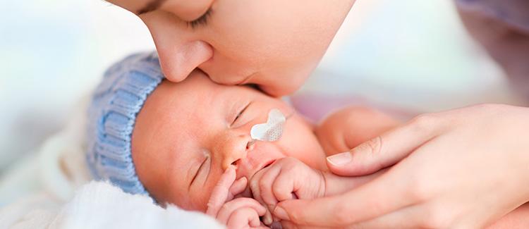 Mom hugging preterm baby