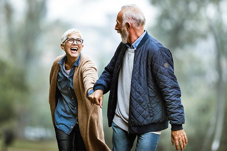 old couple walking in the forest