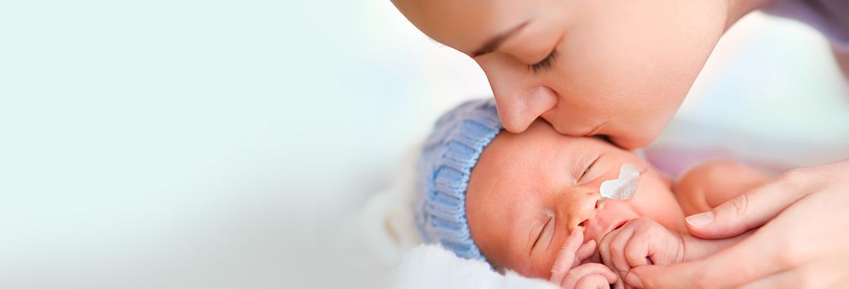 Mum hugging preterm baby