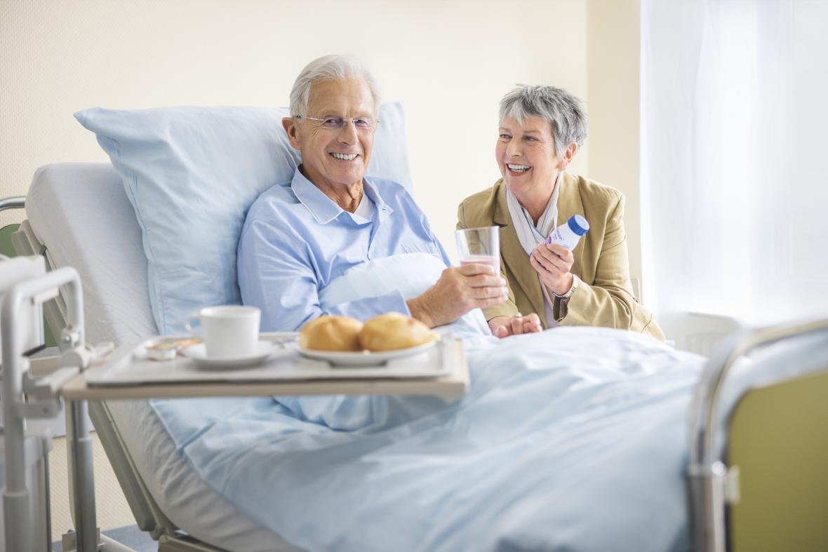 Älterer Patient im Krankenhausbett trinkt Fresubin - verlinkt zu Ernährung bei Erkrankungen (Warum Fresubin)