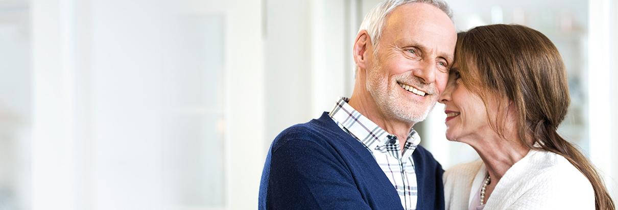 Ältere Frau, die unter Mangelernährung leidet, lehnt sich an ihren Ehemann. Mangelernährung tritt häufig als Begleiterscheinung bei verschiedensten Krankheitsbildern auf.