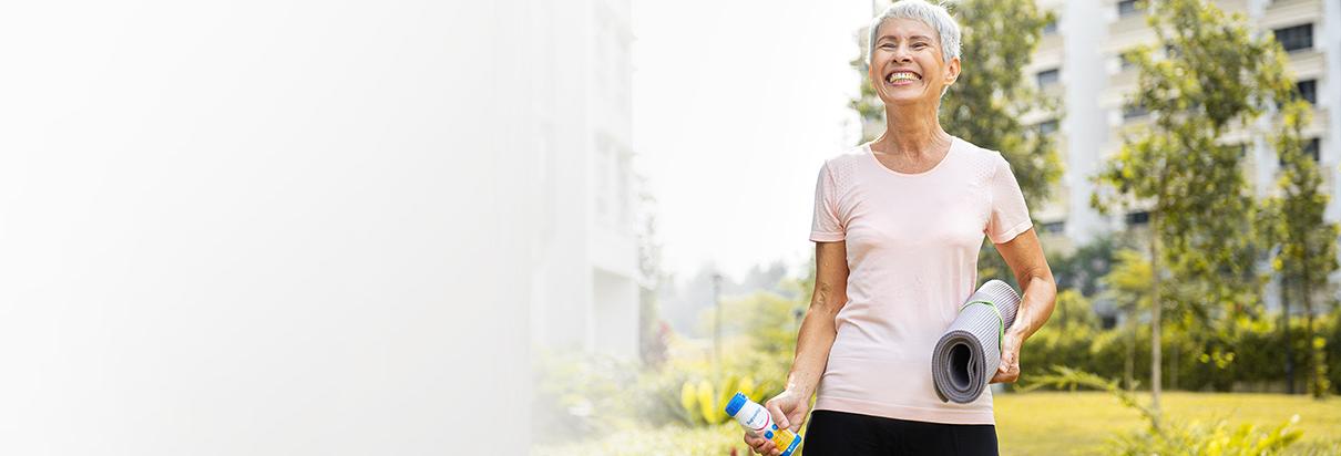 smiling woman with yoga matte